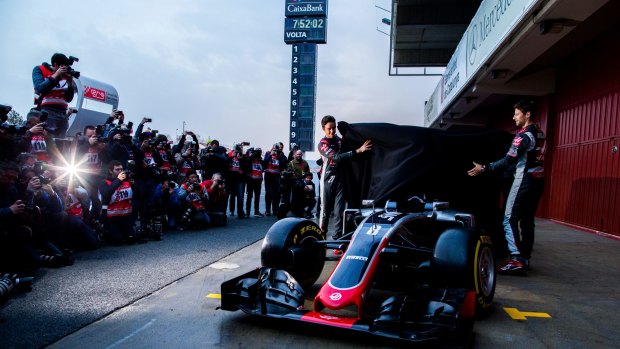 Grand unveiling:  Drivers Romain Grosjean and Esteban Gutierrez reveal the new 
team Haas car during F1 winter testing at Circuit de Catalunya, Barcelona.