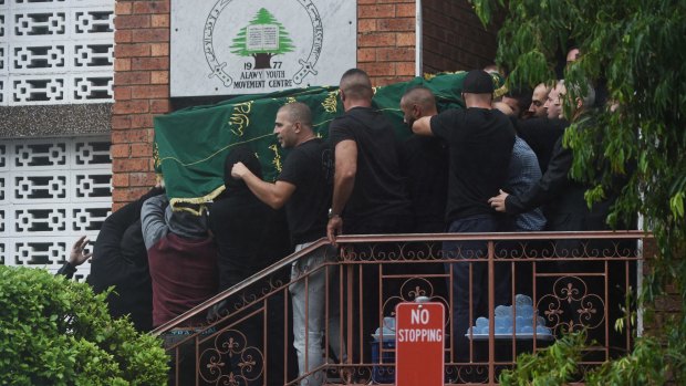 Mr Barakat's coffin is carried out of the Alawi Youth Movement Centre.