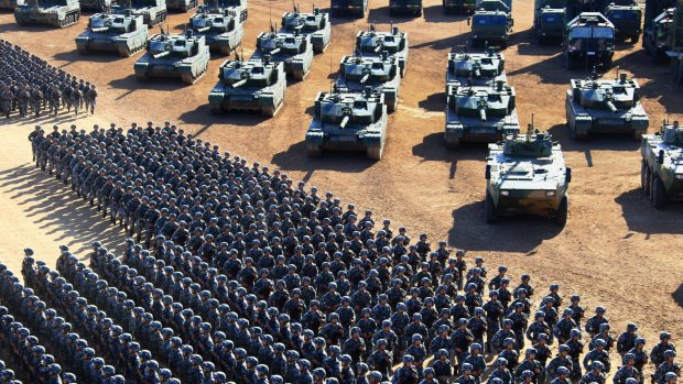 People's Liberation Army troops march past a range of military vehicles at the parade, the first of its kind to mark Army Day.
