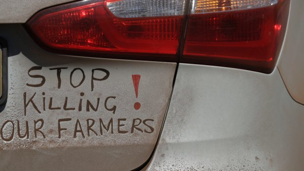 A bumper sign during a blockade of the freeway between Johannesburg and Vereeniging, in Midvaal, South Africa, last year in protest against the murder of farmers.