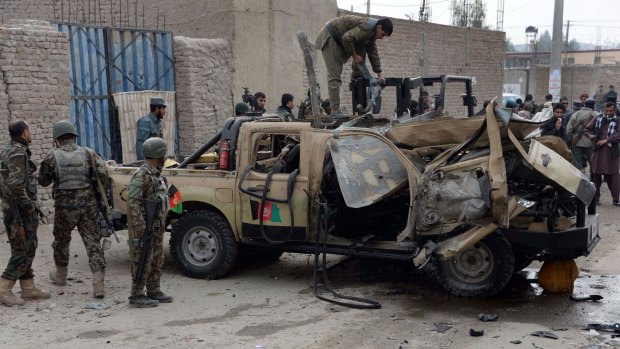 Increasing violence: Afghan National Army soldiers inspect a damaged military vehicle after a remote-controlled bomb blast in Jalalabad on Saturday.