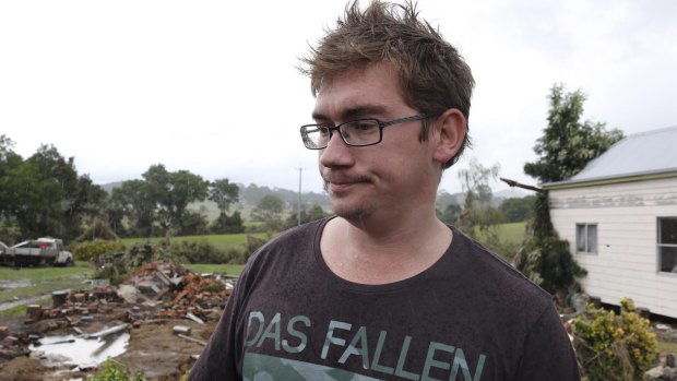 Keegan Taylor at the site of his house, which was washed away by flood
waters in Dungog. 

