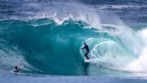 Pro surfer Perth Standlick stands tall in a clean barrel at Cape Solander on Wednesday.
