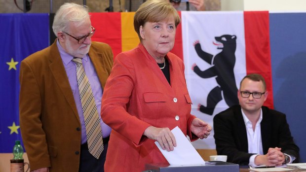 Germany's chancellor Angela Merkel, the Christian Democratic Union party leader, casts her vote in Berlin Sunday.