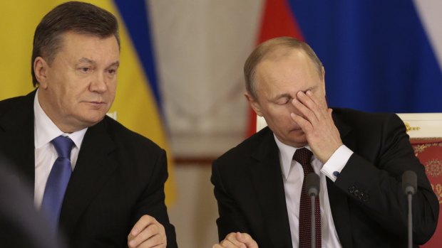 Russian President Vladimir Putin, right, and his then Ukrainian counterpart Viktor Yanukovych in Moscow in 2013. Yanukovych now lives in Russia.