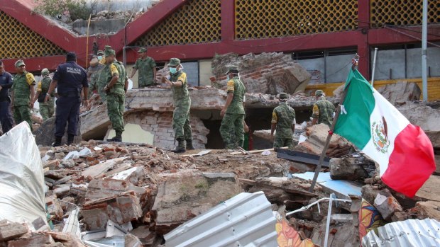 Soldiers remove debris from a partly collapsed municipal building felled by a massive earthquake in Juchitan, Oaxaca state, Mexico.