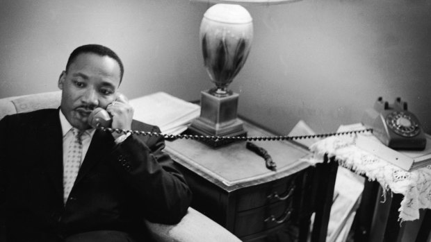 American civil rights leader Dr. Martin Luther King, Jr. (1929 - 1968) sits on a couch and speaks on the telephone after encountering a white mob protesting against the Freedom Riders in Montgomery, Alabama, May 26, 1961.