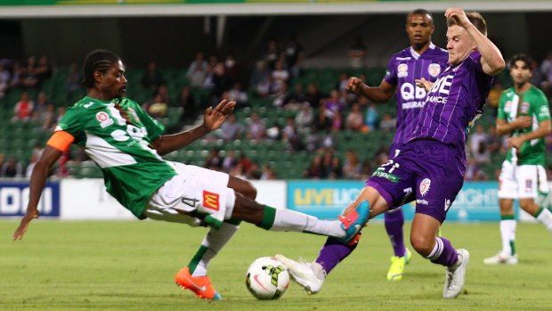 Scott Jamieson of Perth Glory is tackled by Kew Jaliens of the Jets during the A-League match at nib Stadium in Perth on Friday.