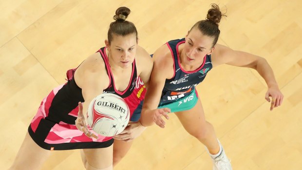 Emily Mannix of the Vixens and Karyn Bailey of the Thunderbirds compete for the ball.