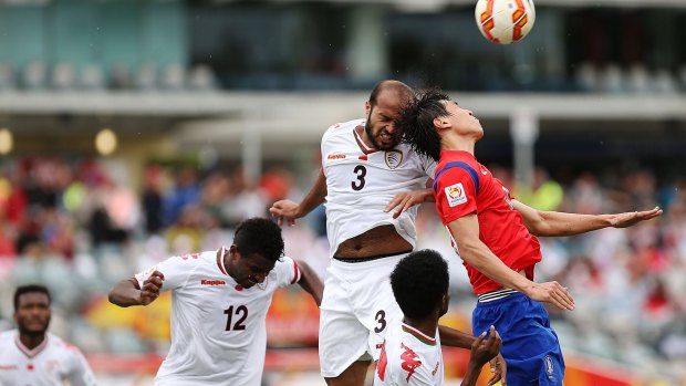 Heads up: Jaber Al Owaisi of Oman and Koo Ja Cheol of South Korea contest a high ball at Canberra Stadium on Saturday.