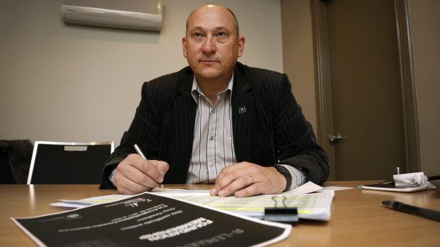 A-League4Canberra bid leader Ivan Slavich writes out refund cheques for people who supported the bid.