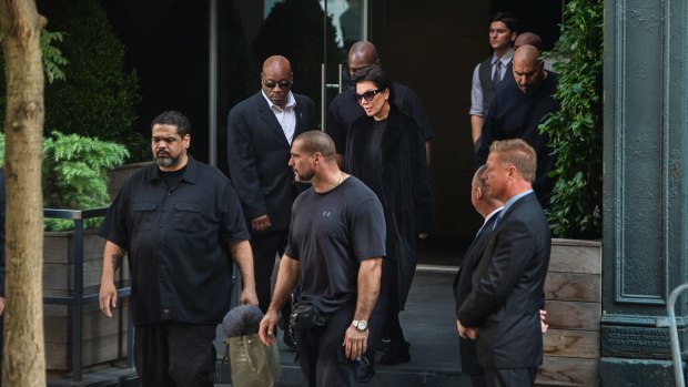Kardashian West's mother Kris Jenner surrounded by security as she leaves the New York residence where her daughter is staying on Monday.