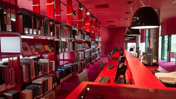 The heritage floor is decorated in bright red, with technology such as PCs, scanners and microfilm readers sitting alongside books and maps.