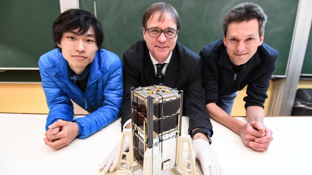 Iver Cairns (centre), Jiro Funmoto and Wayne Peacock with the Inspire-2 cubesat.