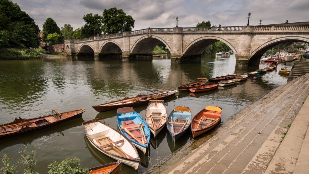 Moored rowing boats with Richmond Bridge in the background, London.