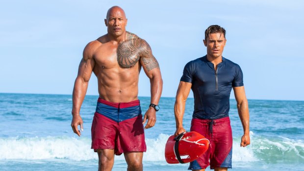 Buff daddy: Dwayne Johnson and Zac Efron in the movie reboot of <i>Baywatch</i>. 