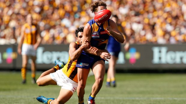 Cyril Rioli tackles Mark Hutchings during Saturday's grand final.