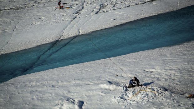 A rope-and-pulley system set up across a river flowing from a supraglacial lake and into a giant hole in the ice, called a moulin, near the researchers' camp in July.
