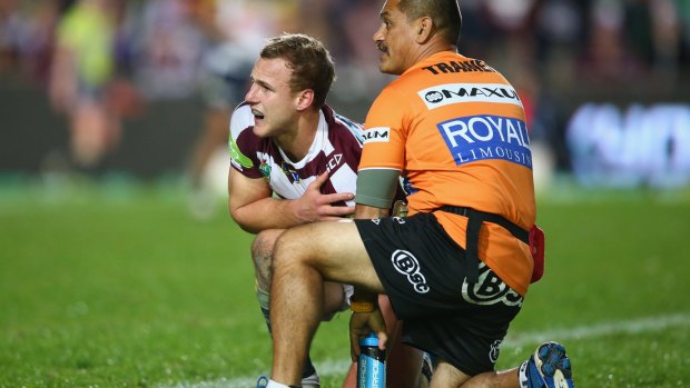 Down and out: Daly Cherry-Evans is treated for a shoulder injury on Monday night. He did not return for the second half.