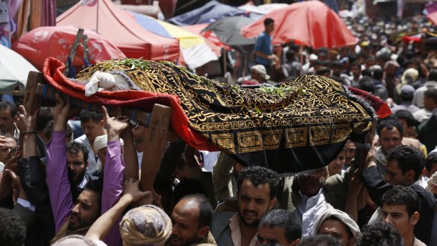 People carry the body of a Yemeni who was killed in a Saudi-led airstrike, during the funeral in the Old City of Sanaa on Saturday.