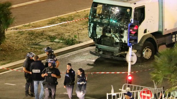 Police investigate the scene after a truck plowed through Bastille Day revellers in the French resort city of Nice.