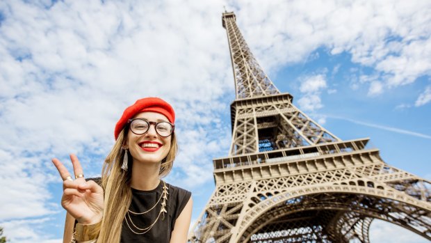 Woman tourist posing at Eiffel Tower.