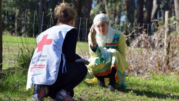 Helping hand. An aid worker and a "refugee" at a Red Cross hostile environment training camp in Yellingbo, east of Melbourne.