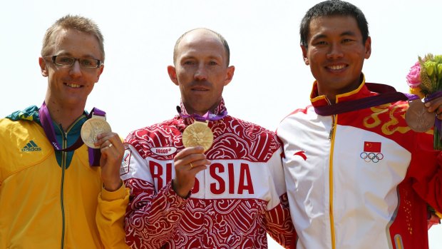 Silver medallist Jared Tallent of Australia, gold medallist Sergey Kirdyapkin of Russia and bronze medallist Tianfeng Si of China pose during the medal ceremony for the Men's 50km Walk at the London Olympics.
