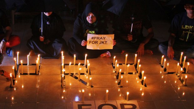 Students light candles during a solidarity for those affected by a deadly attack in Jakarta, during a vigil in Surabaya, East Java, Indonesia.