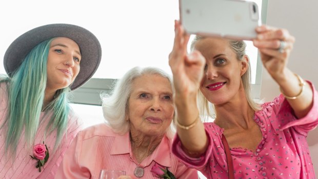 Birthday selfie: Centenarian fashion icon Elvie Hill, centre, with granddaughter Olivia Pelman, left, and step-granddaughter Sophie Rice.