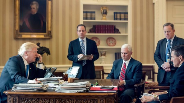 From left: US President Donald Trump, with Chief of Staff Reince Priebus, Vice-President Mike Pence, Press Secretary Sean Spicer and Michael Flynn, speaks on the phone with Russian President Vladimir Putin on January 28.