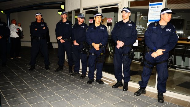 Police line up at Cessnock City Council, where protesters gathered as a mosque was approved on Wednesday night.