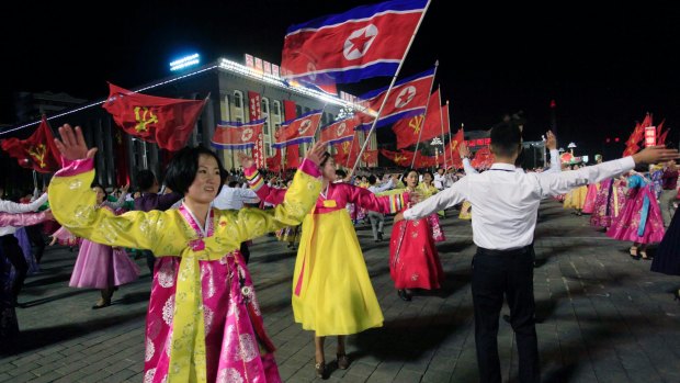 Men and women participate in a mass dance event in October marking the 20th anniversary of former leader Kim Jong-iI's election.
