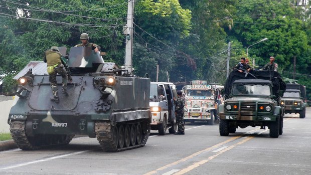 Tanks arrive at a military camp in Iligan to reinforce government troops battling Muslim militants who have laid siege to Marawi.