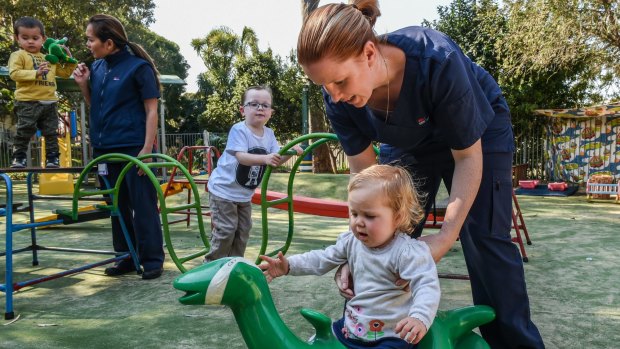 Nurses Jennifer Richards (left), with her son Noah, and Ashleigh Stuart, with son Keaton and daughter Paige, both rely on the Koala Child Care Centre at Sutherland Hospital, which has had its funding pulled.