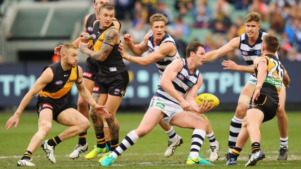 Fast and furious: Geelong midfielder Patrick Dangerfield handballs out of the pack.