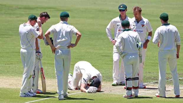 Adam Voges of the Warriors sinks to his knees after being struck in the head by a bouncer from Cameron Stevenson.