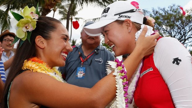 Minjee Lee receives a lei from a hula dancer after winning the LPGA Lotte Championship.