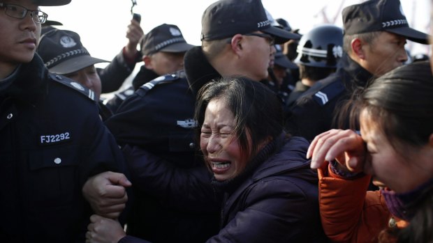 Relatives of a missing person scuffle with police officers on the bank of the Yangtze River, near Jingjiang, Jiangsu province in China.