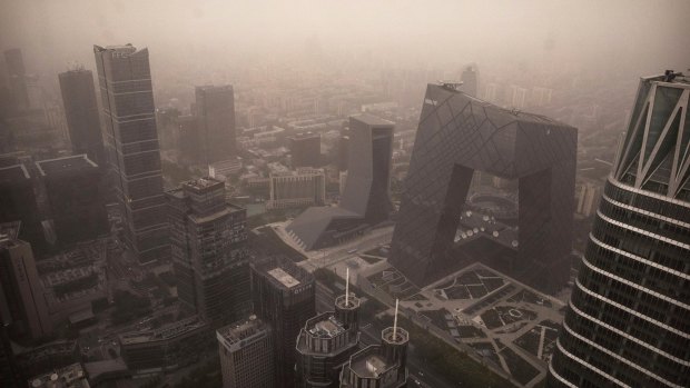 A sandstorm overwhelms the central business district of Beijing on Thursday. 