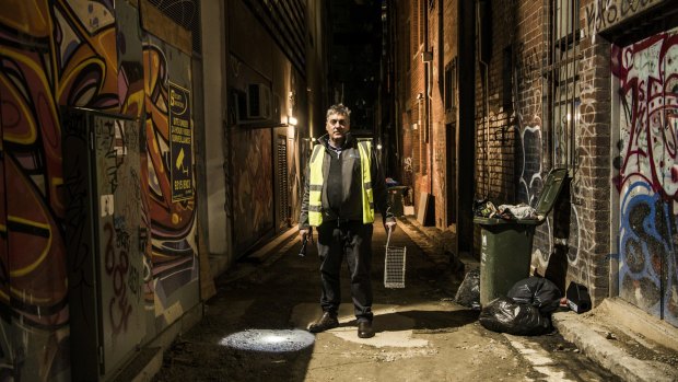 Pest controller David Gay at work in one of Melbourne's laneways.