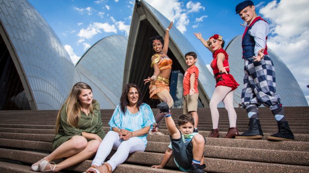 Helen Najjarine and her children, Sorbrine, 18, Bilal, 8, and Ramzi, 3, with performers from Circus 1903 at the Sydney Opera House.