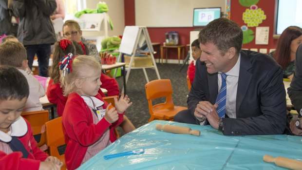 First termers: Premier Mike Baird meets kindergarten student Kassie at the opening day of the Ponds High and Riverbank Public schools.