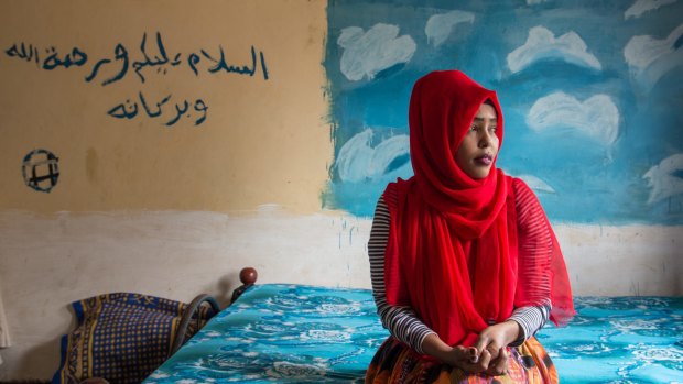 "My cousin still hasn't been found": Hanan Ibrahim, 25, is one of many Somalis living in Kenya affected by the attacks. The Arabic writing on the wall reads "peace be upon you and the mercy of God and His blessings".