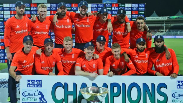 England players pose with the trophy after their win.