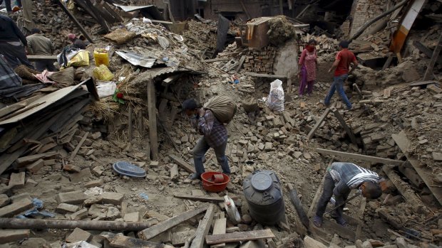 People work near collapsed houses in Bhaktapur, Nepal.