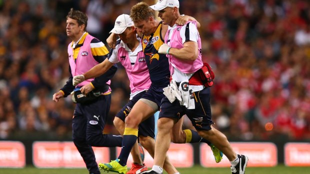 Sam Mitchell leaves the field after hurting his ankle against Sydney.