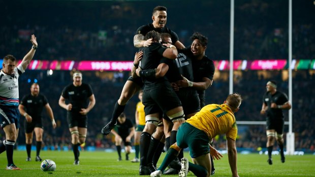 Celebration: Sonny Bill Williams jumps on the huddle after Ma'a Nonu scores New Zealand's second try.