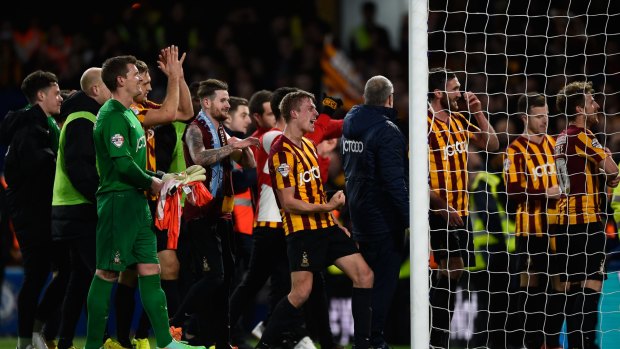 Bradford players celebrate following their shock defeat of Chelsea.