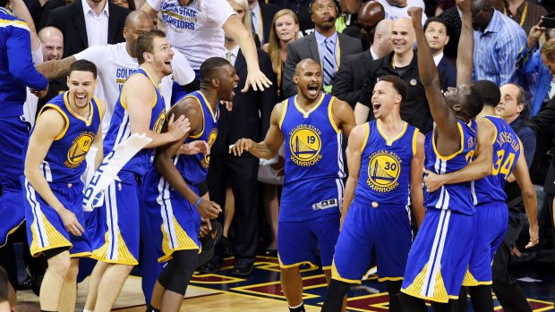 The Warriors celebrate their 105 to 97 win over the Cavaliers.